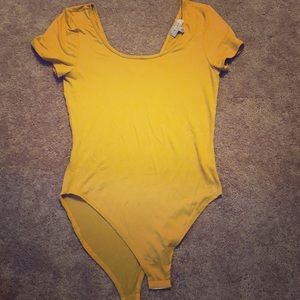 Never worn yellow short sleeve body suit.